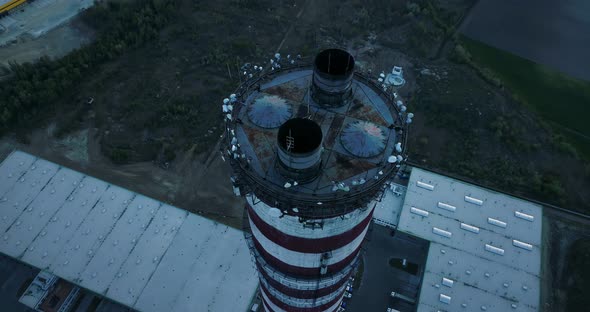 Aerial view on the top of a chimney, camera moving backwards.