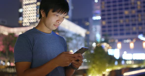 Young man use of cellphone at night