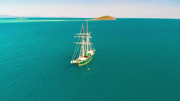 Sailing Ship Sails in a Wonderful Crystal Clear Sea Aerial View From Drone