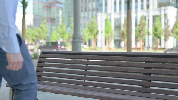 Man Coming and Sitting on Bench Outdoor