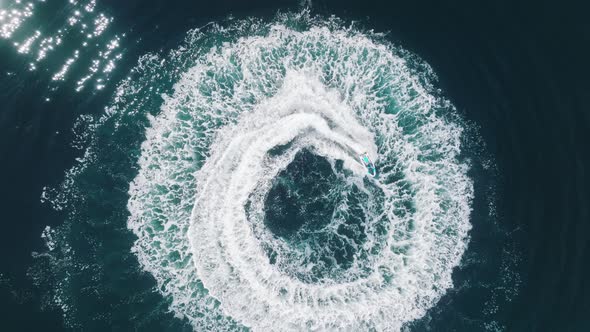 Aerial Epic Shot of Man on Jet Ski Racing on Deep Blue Green Clear Sea Waters