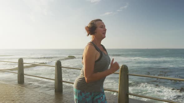 Senior woman running on a promenade