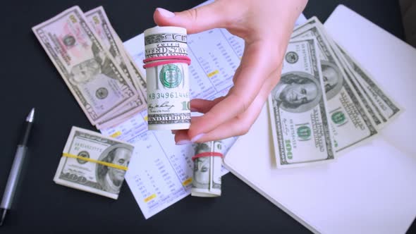 Business Woman Displaying a Spread of Cash US Dollars