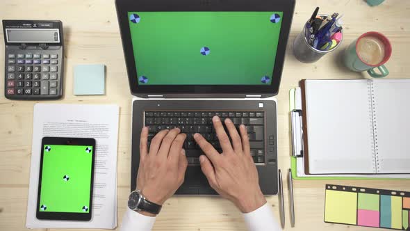 Hands typing on a laptop at work