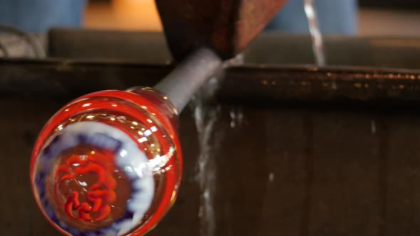 Glassworks glass manufacturing process - glass rolling on the marver