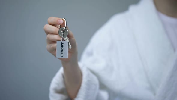 Female in Bathrobe Holding Keys With Resort Word, Spa in Hotel, All Inclusive