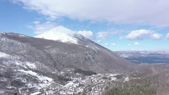 Clouds passing over the snowed Rtanj mountain peak 4K aerial video