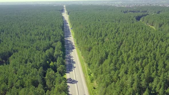 Aerial: Flying Back Over the Highway, Located in Dense Forest