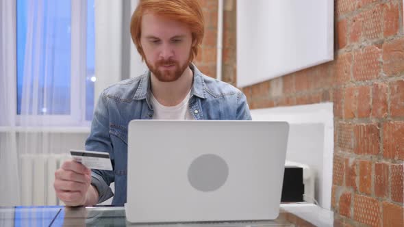 Online Shopping By Redhead Beard Man in Office Credit Card