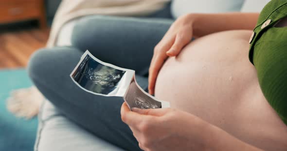 Shot From Above with View of Pregnant Girl Sitting Comfortably on Sofa Wearing Sweatpants and