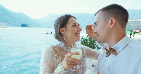 Romantic wedding couple celebrating wedding day holding glasses of champagne