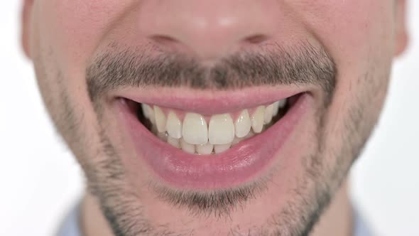 Close Up of Mouth of Smiling Young Man at the Camera , White Background