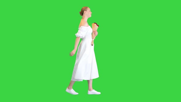 Dreamy Young Girl with Beautiful Bouquet Walking on a Green Screen Chroma Key