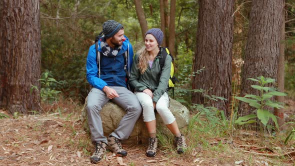 Hiker couple sitting together on rock