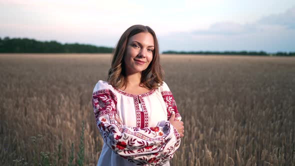 Smiling Ukrainian Woman in Yellow Ripe Wheat Field