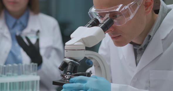 Students Are Studying Chemistry in University, Working with Reagents and Microscope in Class