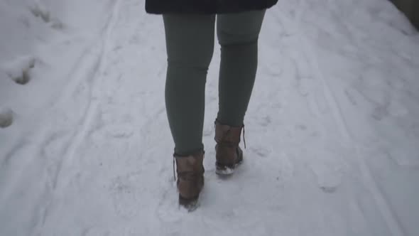 Slow Motion Shot Of A Woman Walking Alone On A Snowy Street