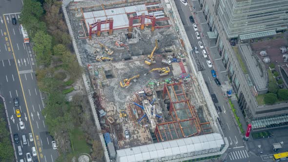 Construction Time Lapse - Aerial View of Yellow Excavators Operation at Construction Site Next to Bu