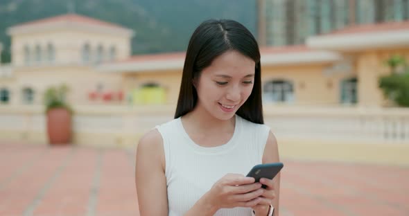 Woman use of mobile phone in city