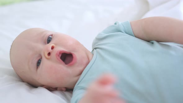 Beautiful Baby Lying in Bed Looking to Camera Happy Infant Bedroom Sunny Day