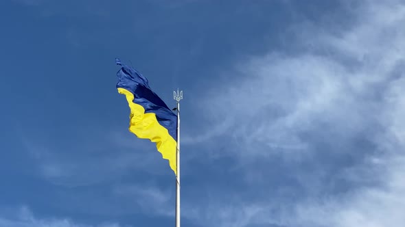 Flag of Ukraine Blue and Yellow Colors Swaying in the Wind Against the Background of a Bright Blue