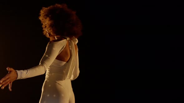 Smiling African American Woman with Afro Style Hairs Dancing on the Stage