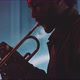 A professional trumpeter plays the trumpet with smoke and neon lights in his room - VideoHive Item for Sale