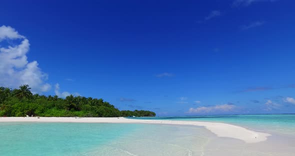 Wide above copy space shot of a white sand paradise beach and blue water background in high resoluti