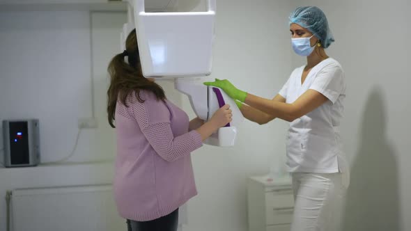 Side View Professional Doctor Using Dental Cone Beam Scanner Examining Plussize Woman in Hospital