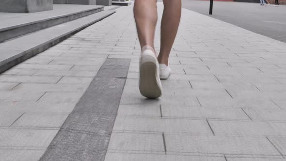 Back View of Walking Legs of Casual Man in Shorts