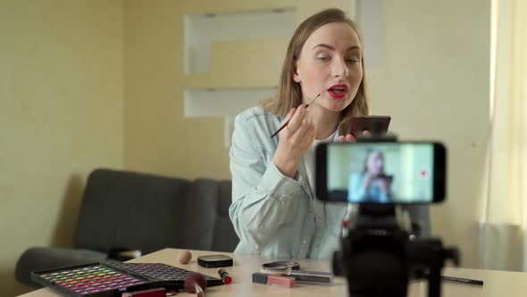 Beauty Blogger Woman Filming Make-up Tutorial on Camera. Influencer Woman Live Streaming Cosmetics