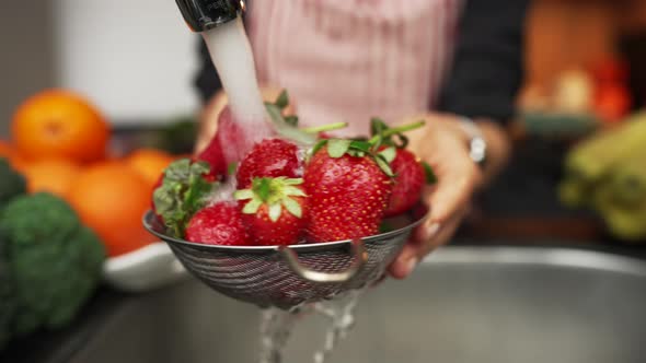 Woman Hands Washing Strawberries in the Kitchen