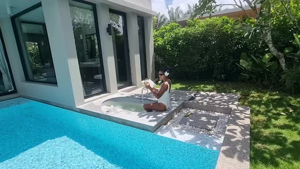 Asian Women on a Luxury Vacation at a Pool Villa