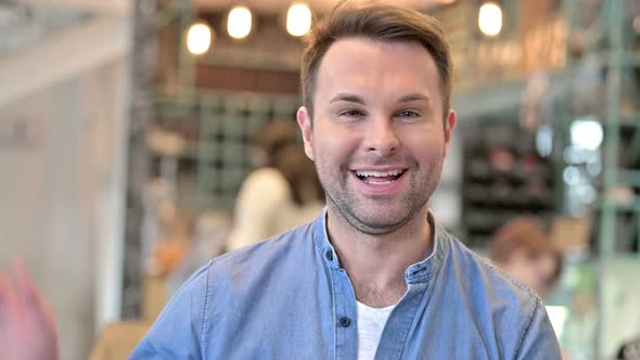 Portrait of Cheerful Casual Man Waving, Welcoming 