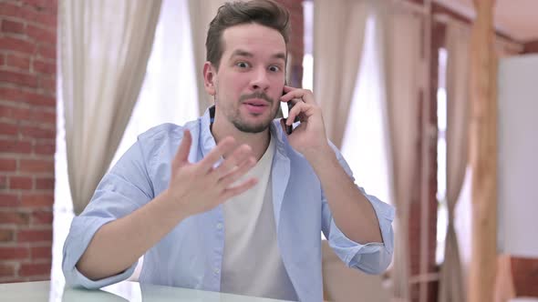 Angry Young Man Having Argument on Smartphone 