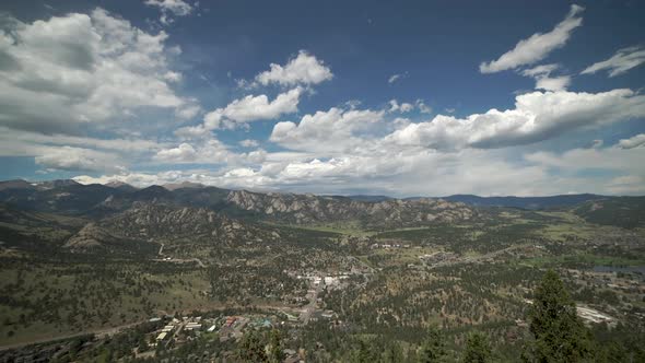 Time lapse of clouds and mountains above touristy mountain town