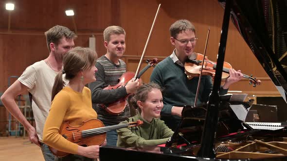 young people in the process of learning to play stringed instruments