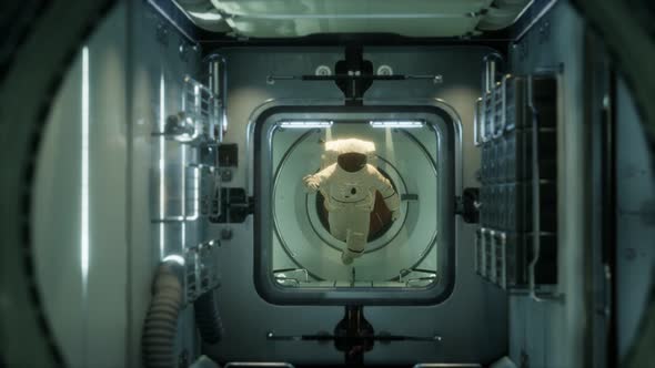 Astronaut Inside the Orbital Space Station