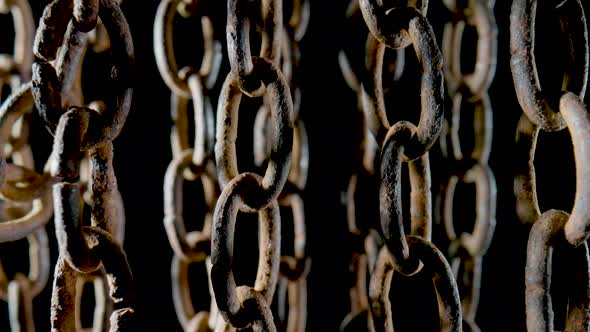 Old Metal Chain with Dark Rusted Links on Black Background