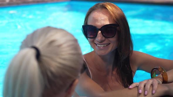 Joyful Redhead Woman in Sunglasses Laughing Listening Blond Friend Talking