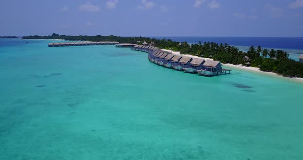 Luxury fly over island view of a white sandy paradise beach and blue sea background 