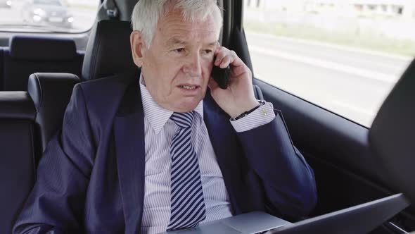 Politician with Phone in Car