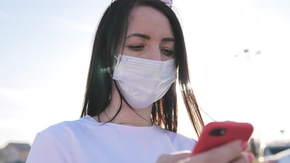 Beautiful Young Woman Wearing Protective Medical Face Mask Standing On The Street