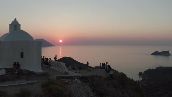 People Tourists Enjoying the Sunset From Church Viewing Point Over Island in Greece