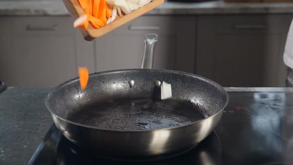 Chef Putting Fresh Vegetables on Frying Pan