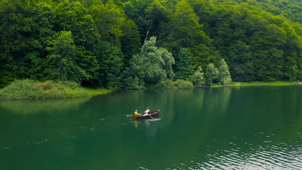 Young Couple are Sailing on a Boat in Biogradsko Lake in Montenegro