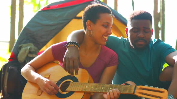 African People on Camping Trip Welcoming a New Day in Summer Park Sing and Play on Guitar