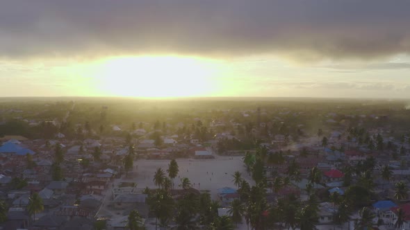 African Village with Metal Houses Palm Trees Streets and a Football Field