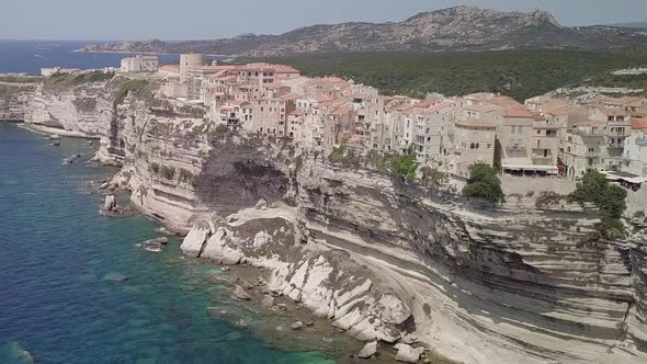 Aerial footageing in from seaside on buildings of Bonifacio