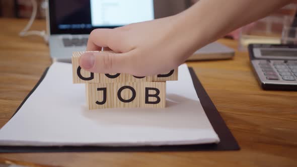 Phrase Good Job is Made Up of Letter Wooden Cubes on an Office Table